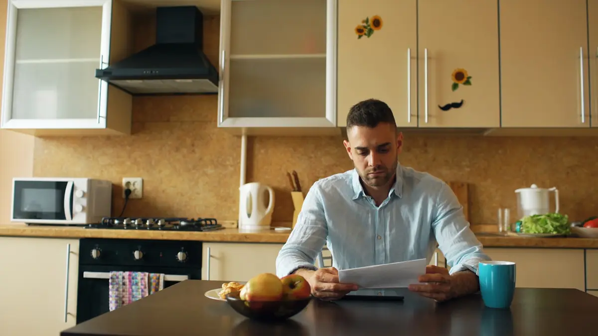 Persona revisando con calma un documento en la cocina al enfrentar una deuda antigua